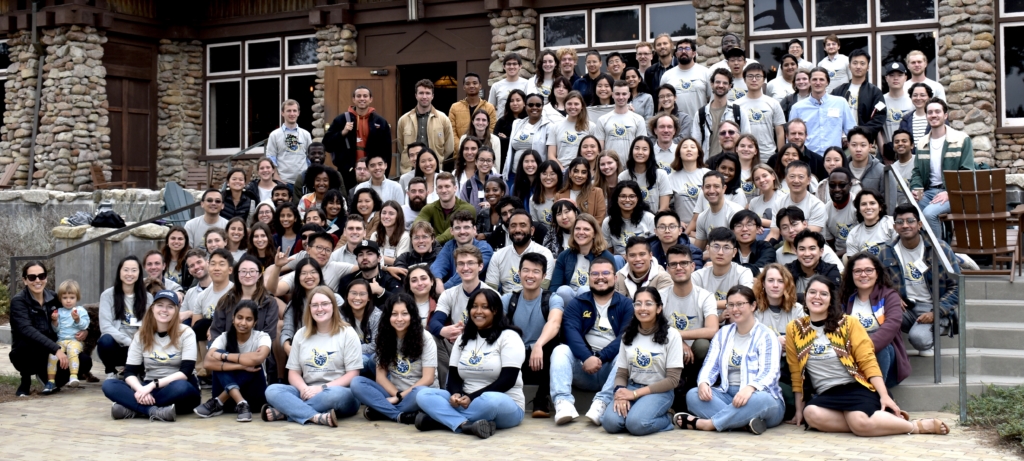 Group photo of students and faculty at the 2022 graduate retreat, all gathered on the steps of the conference center.