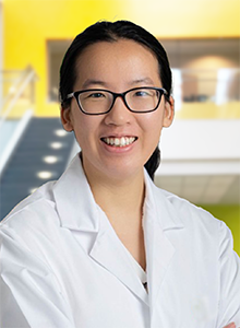 photo of Qihui Lyu in lab coat
