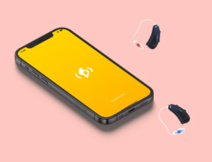 photo of cellphone with Concha Labs logo and two hearing aids